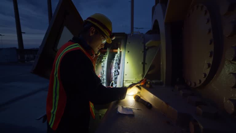 Electrician Working at Power Plant at Night