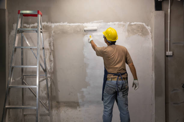istock Prime oil based primer on old concrete wall before applying the main color.  renovation concept 1412989194