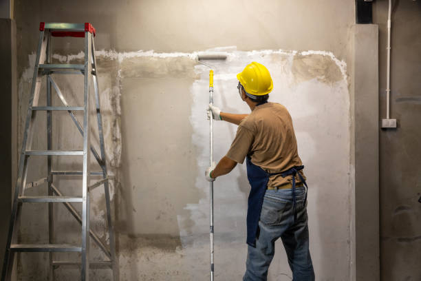 Prime oil based primer on old concrete wall before applying the main color.  renovation concept