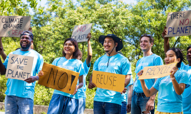 istock Diversity group of volunteer activist demonstrating in protest for global warming and climate change project with written placard for environmental awareness and reducing plastic consumption concept 1412990043