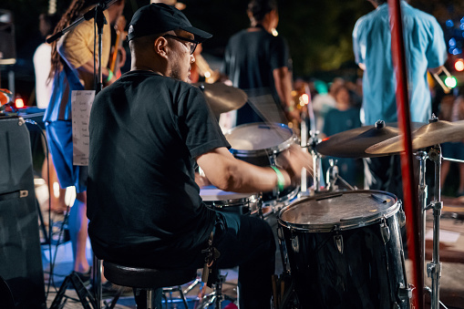 Rear view of a drummer at a outdoor music festival in Japan at night