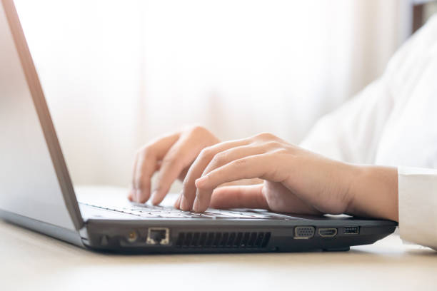 istock Close up woman hand using laptop working online 1412991008