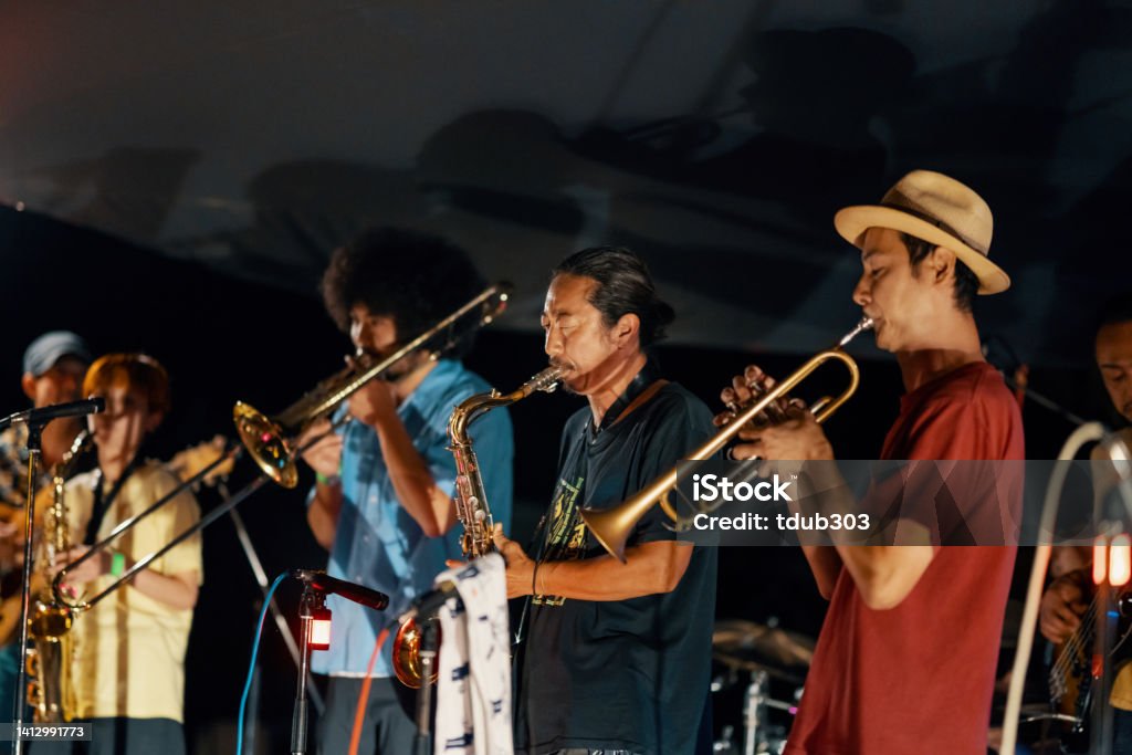 Jazz group playing a live concert at an outdoor music festival Jazz group playing a live concert at an outdoor music festival at night in Japan 20-24 Years Stock Photo
