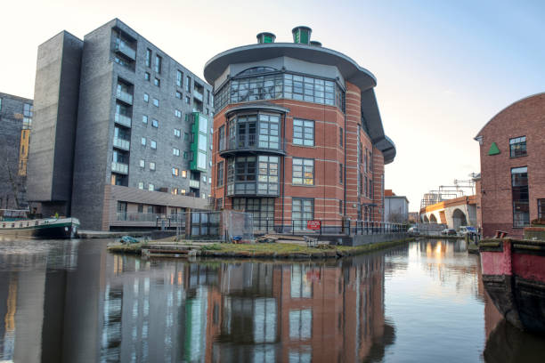 istock Apartment building overlooking canal reflected in calm water below. 1412991858