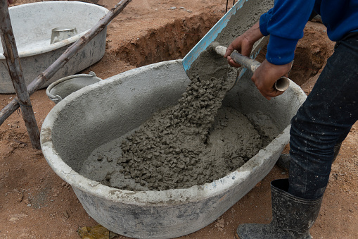 Cement mixed with stone Pour it onto a mortar mixing truck. That is being used by workers.