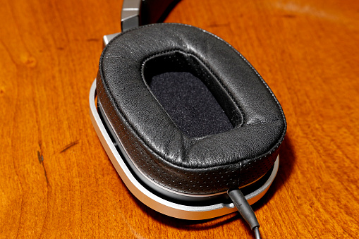 A close up of a single ear piece of a luxury headphone.