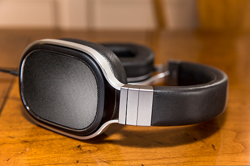 A pair of luxury headphones on a wooden table.