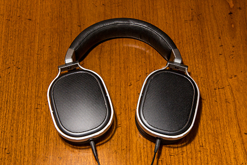 A pair of luxury headphones on a wooden table.