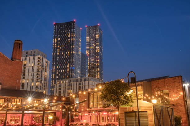 istock Bright lit up restaurant with tall sky scrapers in the late evening skyline. 1412992545