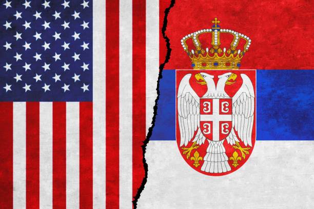 istock USA and Serbia painted flags on a wall with a crack 1412992556