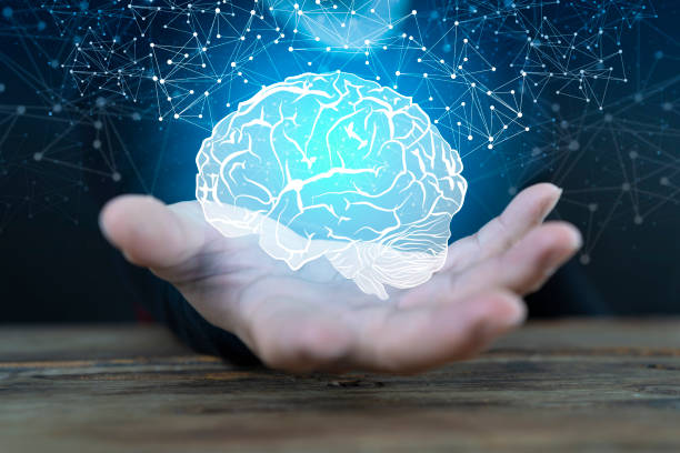 Abstract palm hands holding brain with network connections, innovative technology stock photo