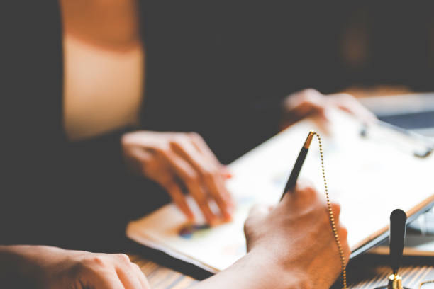 istock business approve and certificate concept, confirmation of business marketing document permit and certified stamping, signing on business partner paper to success, or concept of attorney and insurance 1412997796