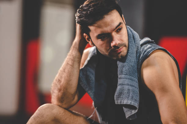 istock strong athlete man person exercising in modern sport gym, active workout exercise training in fitness studio for body strong power and heavy fit, bodybuilding and physical healthy lifestyle people 1412997981