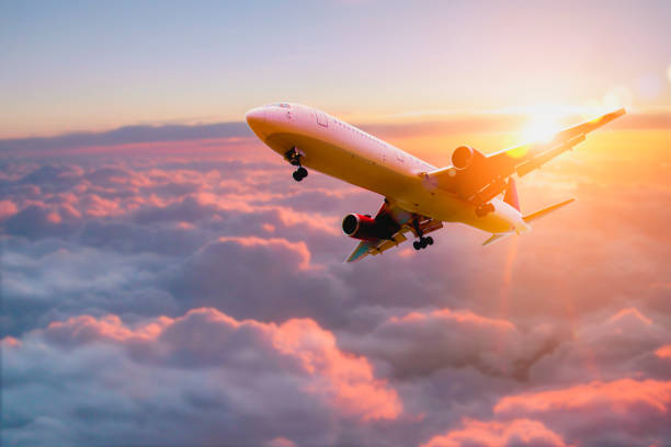 istock Passenger airplane. Passengers commercial airplane flying above clouds in sunset light. Business trip. Commercial plane. Concept of fast travel, holidays and business. 1412999987
