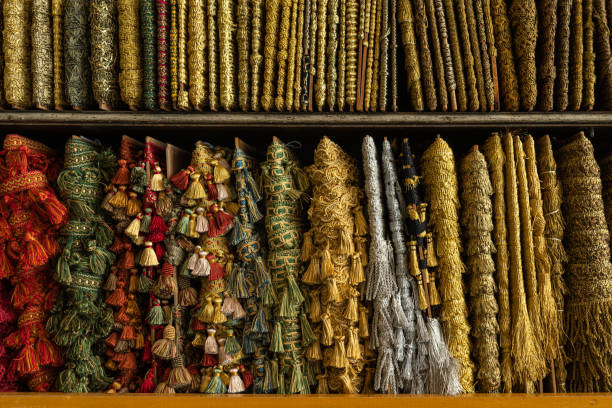 multi-colored bright golden braid located on the counter of the store for decoration, sewing and needlework. Textile background