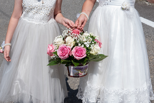 2 girls carry a basket of flowers to a wedding in Romania, Transylvania