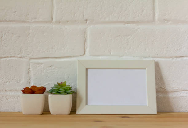 istock An empty photo frame on a table or shelf with a copy of the space. 1413003369