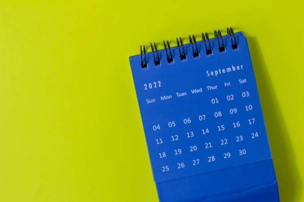 istock Desktop calendar for September 2022 on a yellow background. 1413003392