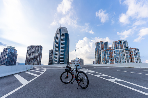 A mountain bike parked on an empty modern urban highway
