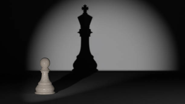 istock A chess pawn that is illuminated and has the shadow of a chess king behind it 1413005861