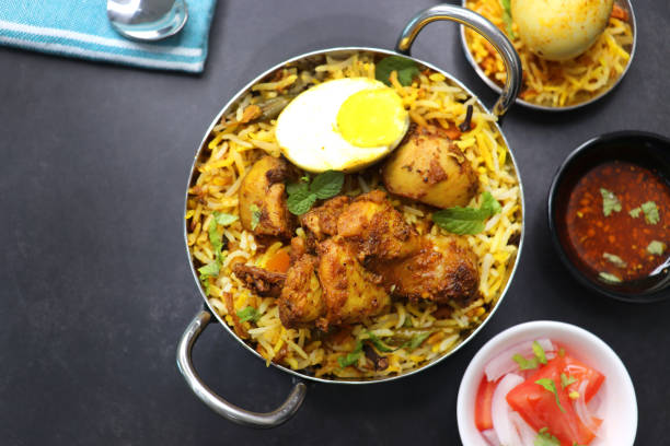 istock Chicken Biryani or murgh Pulao. Garnished with fried onion, mint leaves, and Boiled egg. Biryani is a Spicy nonvegetarian dish of India. Chicken cooked along with Basmati rice. Cucumber Raita. 1413007753