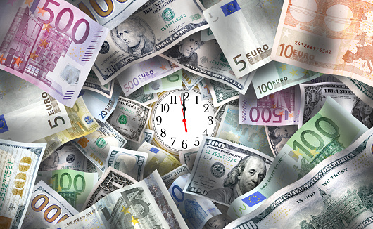 European Union Euro and American banknotes with clock face