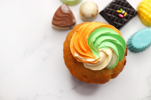 Tiranga Cupcake or Tricolor Cupcake with Indian National Flag colors frosting. saffron or orange, white and green. The concept for Indian happy Independence or Republic day greeting card. copy space.