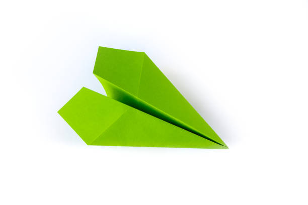 istock Green paper plane origami isolated on a white background 1413011531
