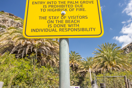 Attention Sign for Palm Grove at Preveli Beach in Crete, Greece