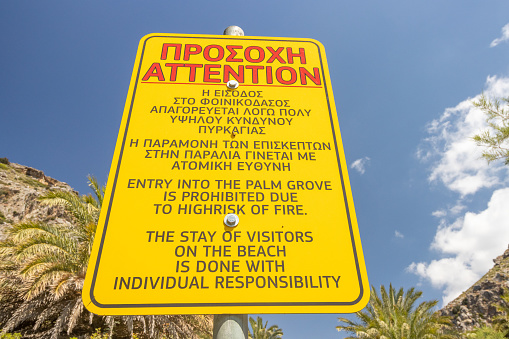 Attention Sign for Palm Grove at Preveli Beach in Crete, Greece