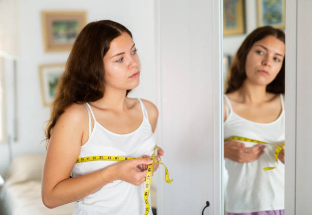 istock Woman measuring bust size using tape measure 1413013002