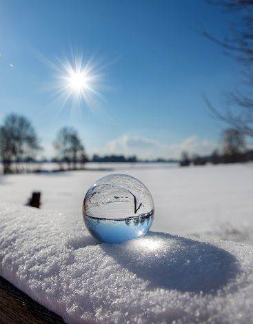 reflection of snow in a glass ball in winter