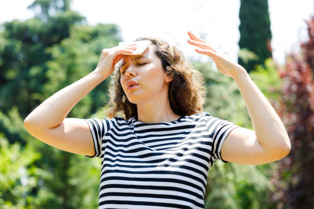 istock Young woman having hot flash and sweating in a warm summer day 1413015243