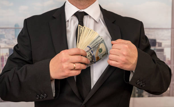 istock a large-scale entrepreneur calculates a salary in dollars and distributes it to workers. 1413017763