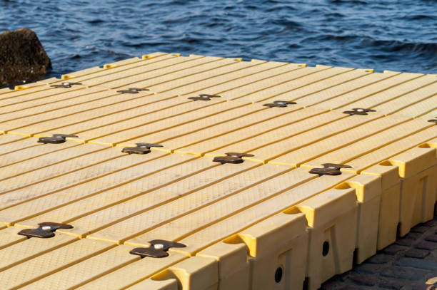 Construction of modular plastic pontoon Construction of modular plastic pontoon. Selective focus floating platform stock pictures, royalty-free photos & images