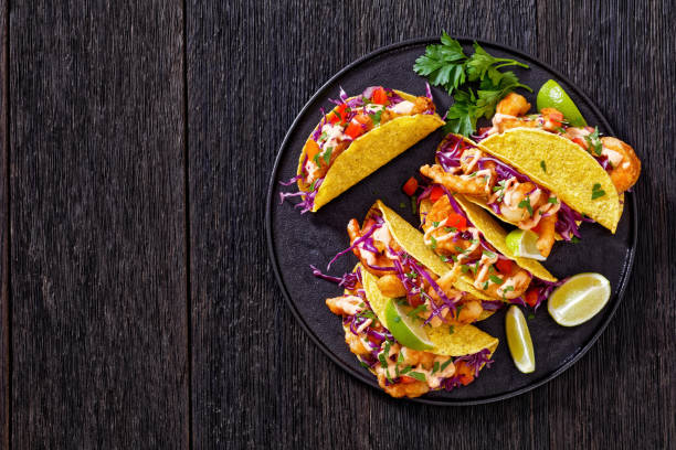 istock Bang Bang Shrimp Tacos on black plate with sauce 1413021383