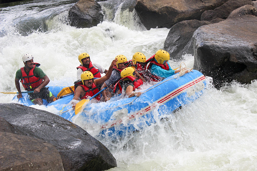 An Action picture of White water rafting in the ferocious river Cauvery in Coorg district of Karnataka, India.