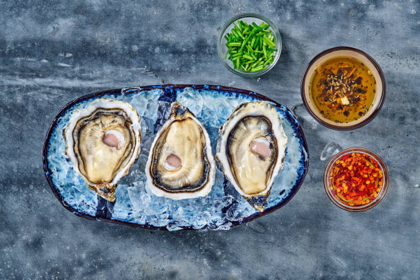 istock Open fresh raw oyster clams isolated and ready to eat 1413024015