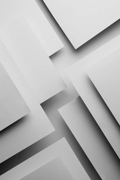 istock White abstract geometric background in simple minimalist style with flying white surfaces as relievo pattern with parallel triangles, stripes, perspective, corners with glow and shadows, vertical. 1413024925