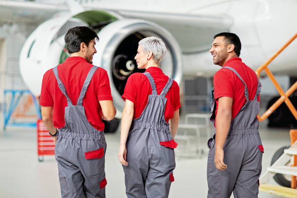 istock Airplane mechanics discussing planned aircraft maintenance in a hangar 1413025563