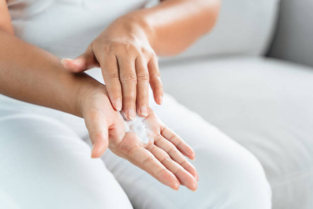 istock Woman applying body lotion moisturizer on her hands. 1413029033