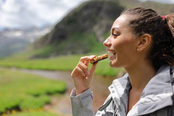 istock Hiker eating a cereal bar in the mountain 1413031745