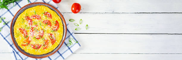 istock Omelette with tomatoes, herbs and grated cheese. Easy breakfast 1413033843