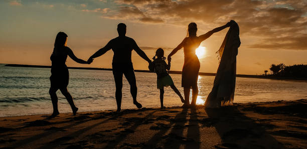istock The family walks along the seashore, sunset. 1413034448