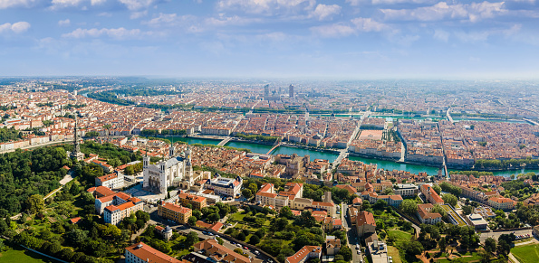 Lyon panorama with Fourviere basilica, Part-Dieu city center Rhone and Saone rivers, France. Aerial view of famous touristic landmarks, French city of lights. Sunny warm summer day, blue sky.