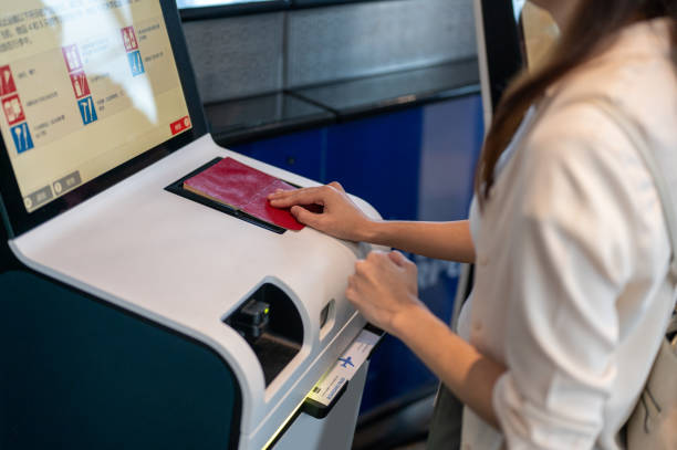 a female hand holding personal passport scanning at the self service checkin counter for get boarding pass at the airport terminal. - airport airport check in counter ticket ticket machine imagens e fotografias de stock