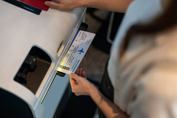 female hand holding personal passport scanning at the self service check in counter for get boarding pass at the airport terminal. - airport airport check in counter arrival departure board checkout counter imagens e fotografias de stock