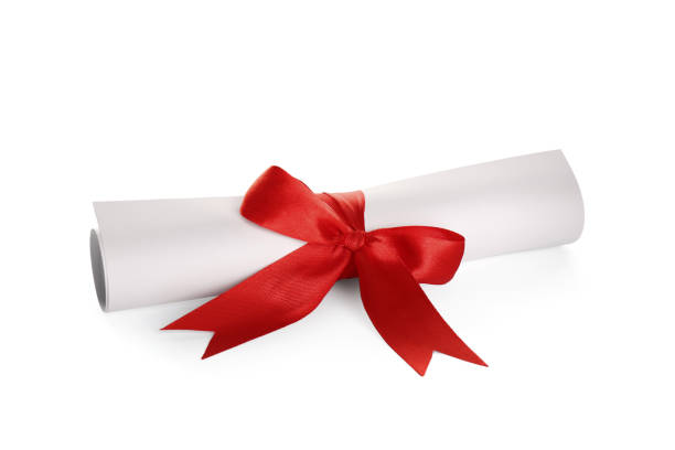 istock Rolled student's diploma with red ribbon isolated on white 1413037514