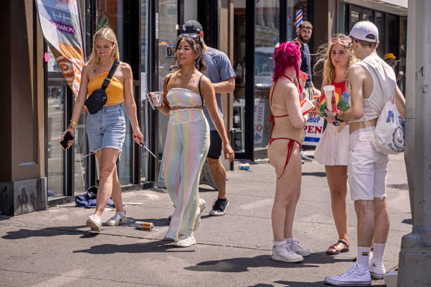 Manhattan, New York, NY, USA - June 26, 2022: People in different dresses on a hot summer day at the New York pride on 6th Avenue