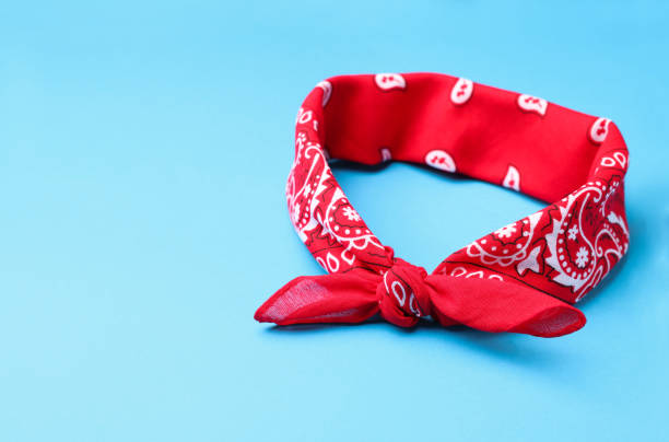istock Tied red bandana with paisley pattern on light blue background, space for text 1413039937